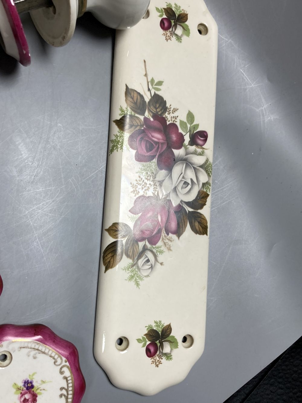 Five pairs of French porcelain door handles and ten porcelain door plates